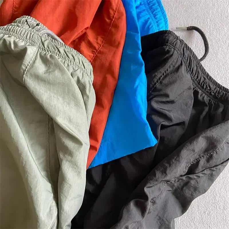 Top quality luxury knee-length summer youth leisure sports nylon shorts loose men's beach 5-point pants